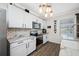 Modern kitchen with stainless steel appliances, white cabinets, and contemporary lighting at 7107 58Th E Ter, Palmetto, FL 34221