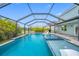 A screened pool with spa and sun shelf, features a covered lanai perfect for outdoor entertaining at 7107 58Th E Ter, Palmetto, FL 34221