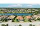 Aerial view of a waterfront community, featuring stunning views of the lake, lush landscaping, and well-maintained properties at 7113 Whittlebury Trl, Bradenton, FL 34202