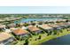 Expansive aerial view of a community with lakefront homes featuring screened-in pools and well-manicured lawns at 7113 Whittlebury Trl, Bradenton, FL 34202