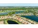 Panoramic aerial view showcasing a well-planned residential area with golf course and lake views at 7113 Whittlebury Trl, Bradenton, FL 34202