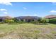Expansive backyard with a well-manicured lawn, tropical landscaping, and a screened-in lanai, blending indoor-outdoor living at 7113 Whittlebury Trl, Bradenton, FL 34202