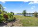 Landscaped backyard with a tranquil lake view, offering a serene outdoor retreat and appealing nature scenery at 7113 Whittlebury Trl, Bradenton, FL 34202