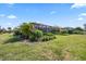 Lush backyard showcasing tropical landscaping and screened-in lanai, creating a private and inviting outdoor space at 7113 Whittlebury Trl, Bradenton, FL 34202