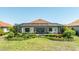 Backyard with screened lanai, well-maintained landscaping, and plenty of space for outdoor enjoyment and activities at 7113 Whittlebury Trl, Bradenton, FL 34202