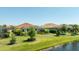 Backyard with screened lanai, landscaping, and pond view perfect for relaxation and outdoor entertainment at 7113 Whittlebury Trl, Bradenton, FL 34202
