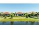 Backyard with screened lanai, landscaping, and pond view perfect for relaxation and outdoor entertainment at 7113 Whittlebury Trl, Bradenton, FL 34202