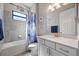 Bathroom featuring a vanity, toilet, tub, and a decorative shower curtain at 7113 Whittlebury Trl, Bradenton, FL 34202