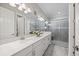 Bright bathroom with dual sinks, marble counters, and a glass-enclosed shower at 7113 Whittlebury Trl, Bradenton, FL 34202