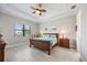Relaxing bedroom features a ceiling fan, comfortable furniture, and serene natural lighting at 7113 Whittlebury Trl, Bradenton, FL 34202
