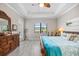 Comfortable bedroom with a ceiling fan, relaxing decor, and plenty of natural light at 7113 Whittlebury Trl, Bradenton, FL 34202