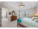 Well-lit bedroom features neutral colors, a ceiling fan, and stylish wood furniture at 7113 Whittlebury Trl, Bradenton, FL 34202