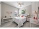 Comfortable bedroom with white furnishings, flamingo decor, and tile floors at 7113 Whittlebury Trl, Bradenton, FL 34202
