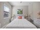 Relaxing bedroom featuring a full-size bed, tropical decor, and lots of natural light at 7113 Whittlebury Trl, Bradenton, FL 34202
