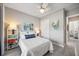 Bedroom with white furnishings, tile floors, and bright, natural light at 7113 Whittlebury Trl, Bradenton, FL 34202