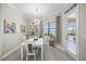 Bright dining area features a modern chandelier, view of the pool, and access to the lanai at 7113 Whittlebury Trl, Bradenton, FL 34202
