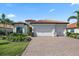 Lovely home with a three-car garage, clay tile roof and lush landscaping at 7113 Whittlebury Trl, Bradenton, FL 34202