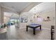 Open-concept game room with pool table and views to the outside at 7113 Whittlebury Trl, Bradenton, FL 34202