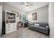Comfortable home office with neutral colors, lots of natural light, and built-in bookcase for storage and display at 7113 Whittlebury Trl, Bradenton, FL 34202