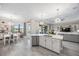 Open-concept kitchen and living area with a center island and views of the pool at 7113 Whittlebury Trl, Bradenton, FL 34202