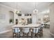 Stylish kitchen with an island bar, modern lighting, and open access to the dining area at 7113 Whittlebury Trl, Bradenton, FL 34202