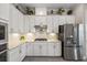 Stylish kitchen featuring white cabinets, stainless steel appliances, and a gas range at 7113 Whittlebury Trl, Bradenton, FL 34202