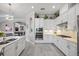 Open kitchen with white cabinetry, stainless steel appliances, and an archway to another room at 7113 Whittlebury Trl, Bradenton, FL 34202