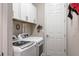 Well-organized laundry room with updated appliances, storage cabinets, and convenient access to the rest of the home at 7113 Whittlebury Trl, Bradenton, FL 34202