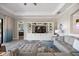 Well-lit living room with a large entertainment center, stylish rug, and access to a bedroom at 7113 Whittlebury Trl, Bradenton, FL 34202