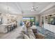 Open-concept living area showcasing a kitchen island, comfortable seating, and access to outdoor amenities at 7113 Whittlebury Trl, Bradenton, FL 34202