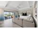 Spacious living room with custom built-ins, tray ceilings, and sliding glass doors leading to the backyard at 7113 Whittlebury Trl, Bradenton, FL 34202