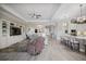 Expansive living area featuring an entertainment center, a kitchen with bar seating, and open layout at 7113 Whittlebury Trl, Bradenton, FL 34202