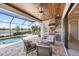 An amazing outdoor kitchen, pool and lounge are shown on the screened-in lanai at 7113 Whittlebury Trl, Bradenton, FL 34202