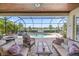 Inviting screened-in lanai with outdoor seating, pool, spa, and picturesque water views, perfect for relaxing and entertaining at 7113 Whittlebury Trl, Bradenton, FL 34202
