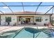 Outdoor pool and patio area complete with an outdoor kitchen and lounge furniture at 7113 Whittlebury Trl, Bradenton, FL 34202
