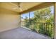 Outdoor balcony with ceiling fan, overlooking a lush green landscape at 7115 Boca Grove Pl # 204, Lakewood Ranch, FL 34202