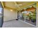 Comfortable balcony with ceiling fan and sliding glass doors, leading into the living area at 7115 Boca Grove Pl # 204, Lakewood Ranch, FL 34202