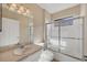 Clean bathroom featuring glass-enclosed shower, large mirror, and sink with ample counter space at 7115 Boca Grove Pl # 204, Lakewood Ranch, FL 34202