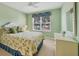 Comfortable bedroom with lots of light, ceiling fan, and a beautiful view of the green landscape outside at 7115 Boca Grove Pl # 204, Lakewood Ranch, FL 34202