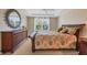 Inviting bedroom offers a ceiling fan, a tray ceiling, and plenty of space at 7115 Boca Grove Pl # 204, Lakewood Ranch, FL 34202