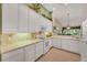 Modern kitchen boasts ample storage, a full appliance package, and views into the home's living spaces at 7115 Boca Grove Pl # 204, Lakewood Ranch, FL 34202
