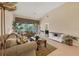 Inviting living room boasts neutral tones, tile flooring, and sliding glass doors to a private balcony at 7115 Boca Grove Pl # 204, Lakewood Ranch, FL 34202