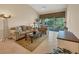 Bright living room features tile floors, comfortable seating, and access to the balcony with a view at 7115 Boca Grove Pl # 204, Lakewood Ranch, FL 34202