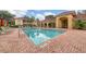 Beautiful view of a community pool with brick accents and lounge chairs for relaxation at 7115 Boca Grove Pl # 204, Lakewood Ranch, FL 34202