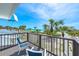 Spacious balcony overlooking a pristine beach with palm trees and turquoise water at 722 N Manasota Key Rd, Englewood, FL 34223
