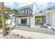 Rear exterior featuring a balcony, covered patio, and tropical landscaping at 722 N Manasota Key Rd, Englewood, FL 34223