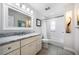 Bathroom featuring a single sink vanity with a marble countertop and a shower with white tile at 722 N Manasota Key Rd, Englewood, FL 34223
