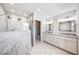 Bright bathroom showcasing a glass shower, marble walls, double sink vanity, and white cabinets at 722 N Manasota Key Rd, Englewood, FL 34223