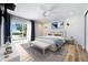 Bedroom features wood floors, a cozy bed, and sliding doors to the outdoor view at 722 N Manasota Key Rd, Englewood, FL 34223