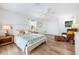 Bedroom with light-toned walls and furnishings and a comfortable sitting area at 722 N Manasota Key Rd, Englewood, FL 34223